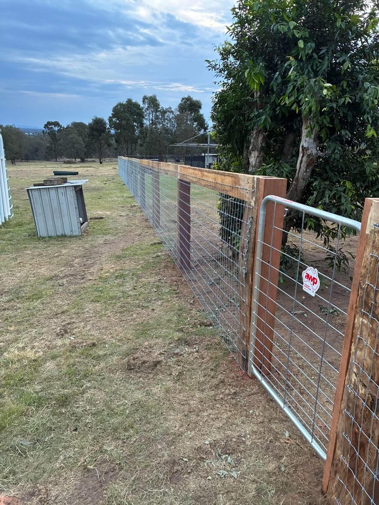 Post and rail with mesh running to a gate